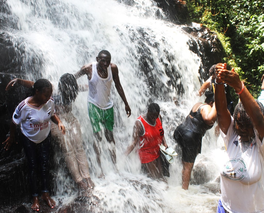 Hike to Bihingi Waterfalls: The Romantic Release; The Climax Baptism of Nature
Nestled in a lush, hidden gorge within the Ibanda hills, the trek to the Bihingi Twin Falls was a perfect, romantic nature walk. The journey took us through an idyllic Ugandan landscape: winding paths through working cattle farms, vast millet gardens, and fragrant banana plantations, before the final, steep, exhilarating scramble down slick rocks to the river valley.