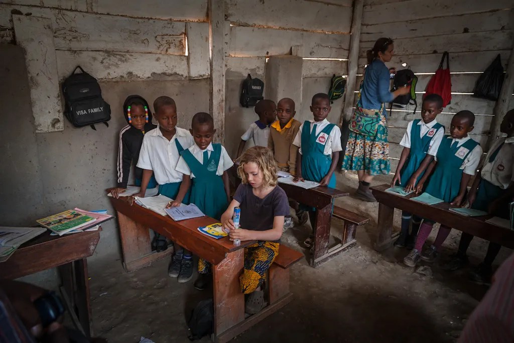 Many schools are built of mud and sticks with cow-dung floors. The children have no chairs and sit on the dirt. Yet, when we entered a classroom, the students would stand perfectly straight and sing a musical "You are welcome."